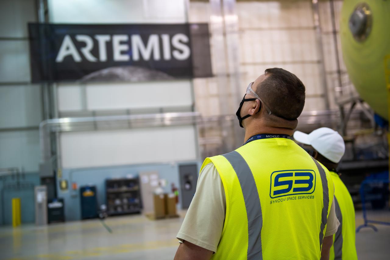 Employees wear personal protective gear at  Michoud Assembly Facility as the facility transitioned to Stage 3 of NASA’s Framework for Return To On-Site Work. Employees wear the appropriate personal protective equipment (PPE) and/or cloth face coverings as required for assigned tasks. Access to the facility is limited to authorized personnel working on mission-critical tasks that must be conducted onsite. Mission-critical tasks include slowly and methodically resuming Space Launch System (SLS) Core Stage and Orion production activities, particularly critical path deliverables to support the Artemis Program, at a pace that limits personnel and follows federal guidelines for social distancing and use of personal protective equipment such as face masks. For more information about SLS, visit nasa.gov/sls.